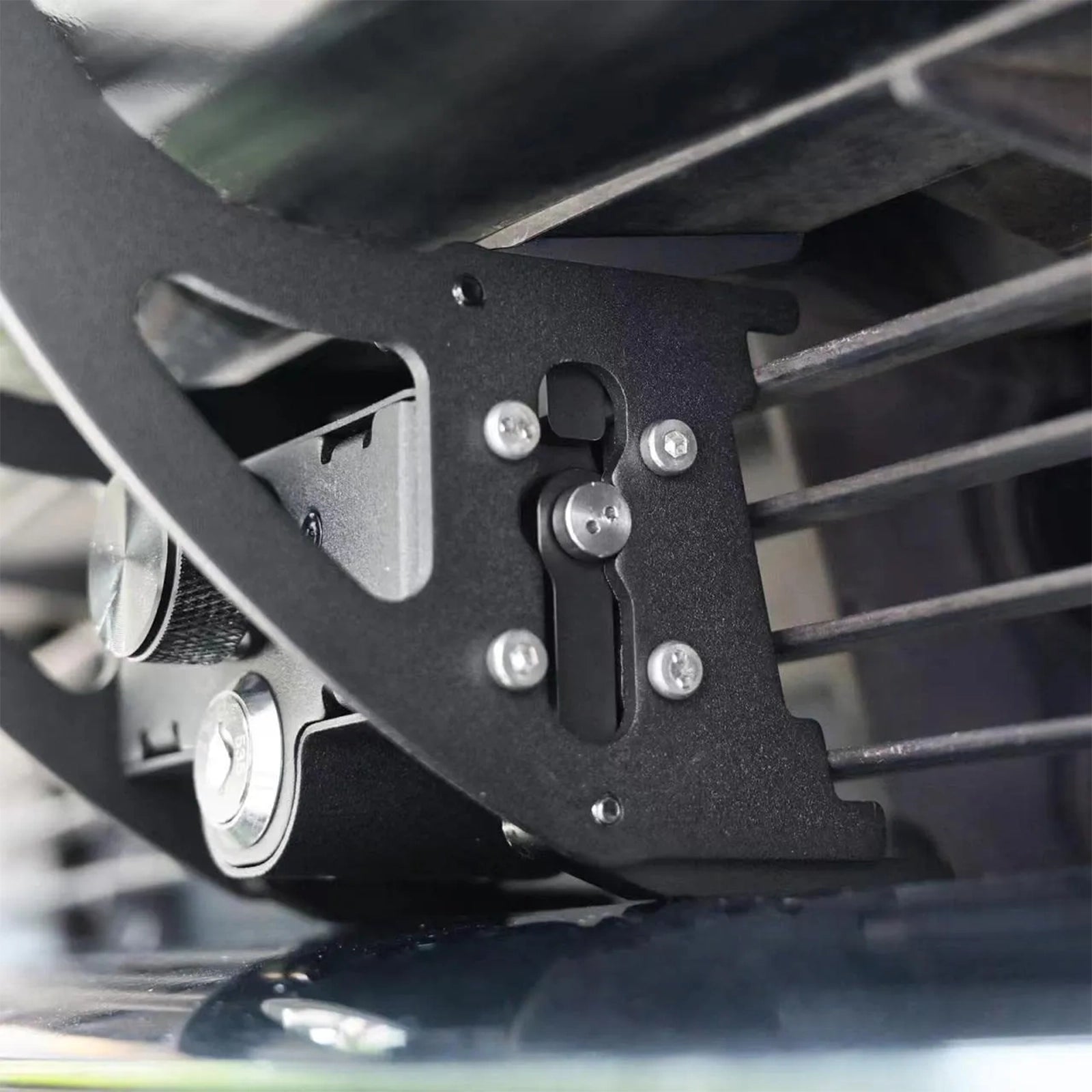 A black metal license plate frame with a locking mechanism for Tesla Model 3/Y.